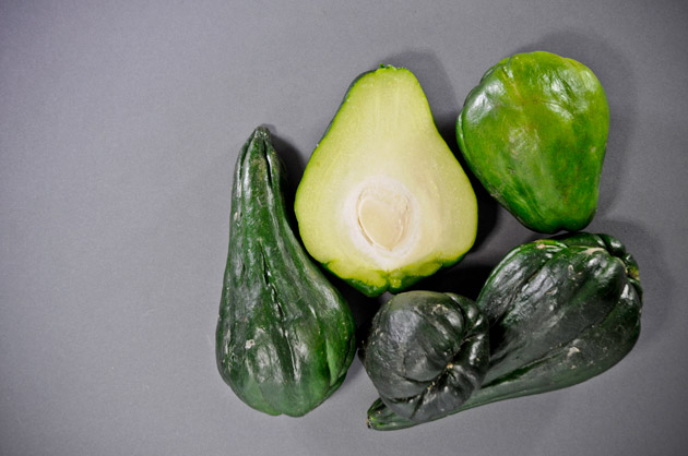 Guisquil, dark green edible vegetable, whole and cut in half. FLAAR Studio